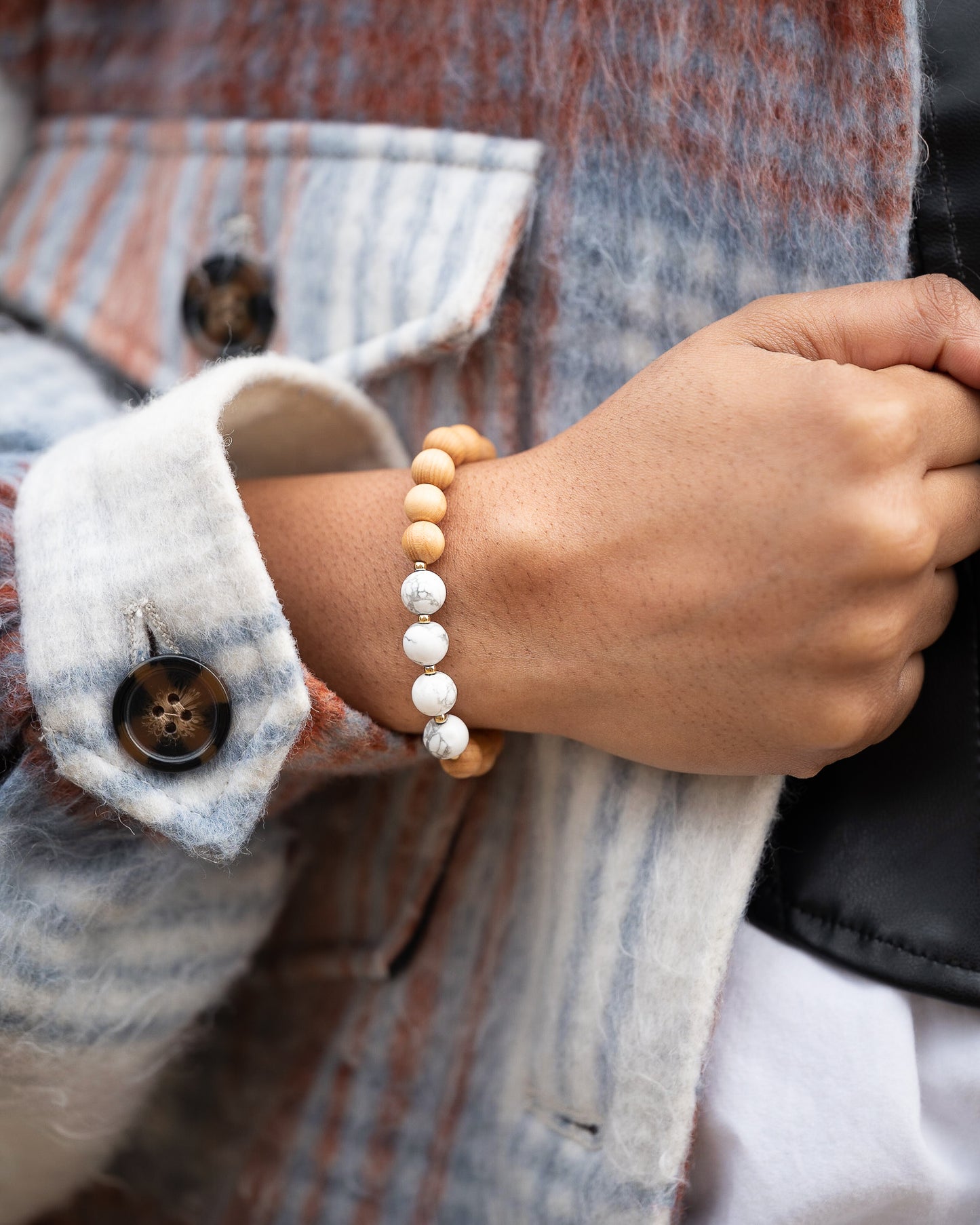 Someone wearing sandalwood gemstone with white howlite